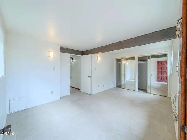 an empty room with a empty space and windows