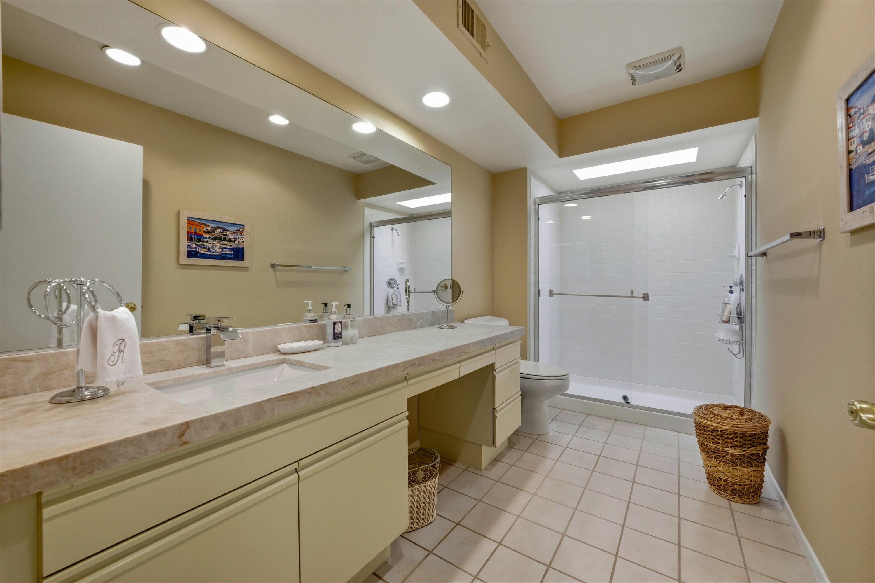 54860 Inverness Way La Quinta, CA 92253 - Photo 11 of 26 a bathroom with a granite countertop sink a toilet and a mirror