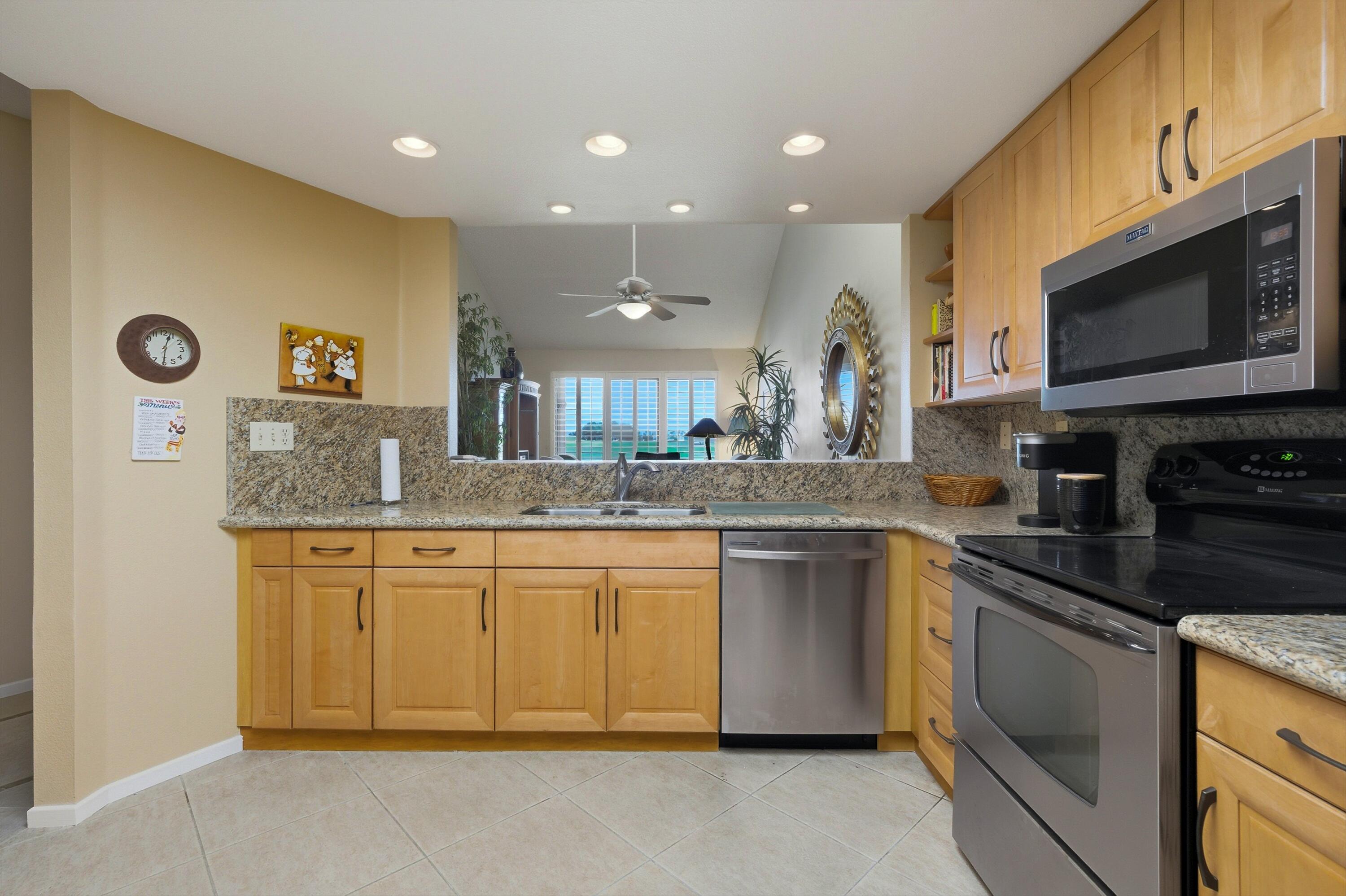 54860 Inverness Way La Quinta, CA 92253 - Photo 25 of 26 a kitchen with stainless steel appliances granite countertop a sink and a stove