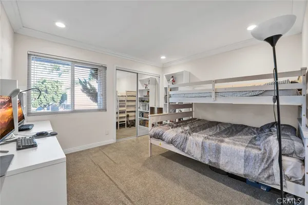 a living room with stainless steel appliances kitchen island granite countertop furniture and a flat screen tv