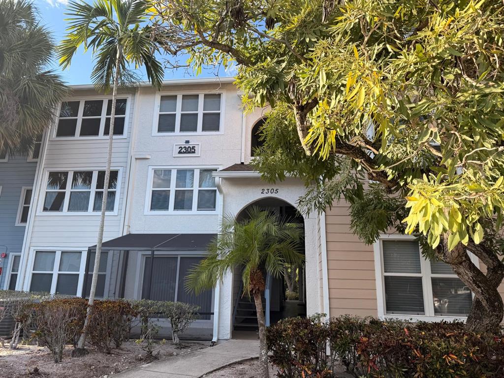 2305 North Congress Avenue Boynton Beach, FL 33426 - Photo 3 of 12 a front view of a house with a garden