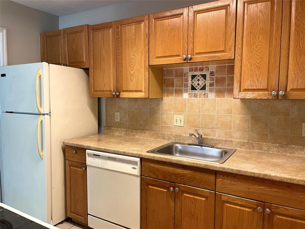 2305 North Congress Avenue Boynton Beach, FL 33426 - Photo 4 of 12 a kitchen with a sink and a refrigerator