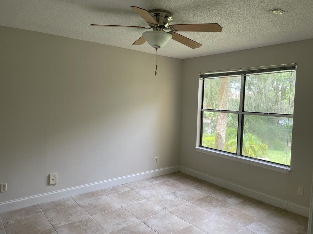2305 North Congress Avenue Boynton Beach, FL 33426 - Photo 7 of 12 an empty room with a window and a fan