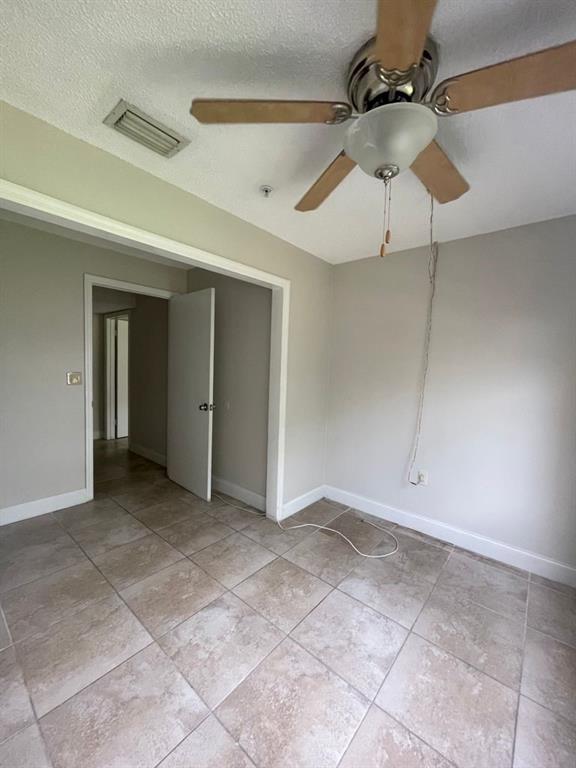 2305 North Congress Avenue Boynton Beach, FL 33426 - Photo 10 of 12 a view of an empty room with a ceiling fan
