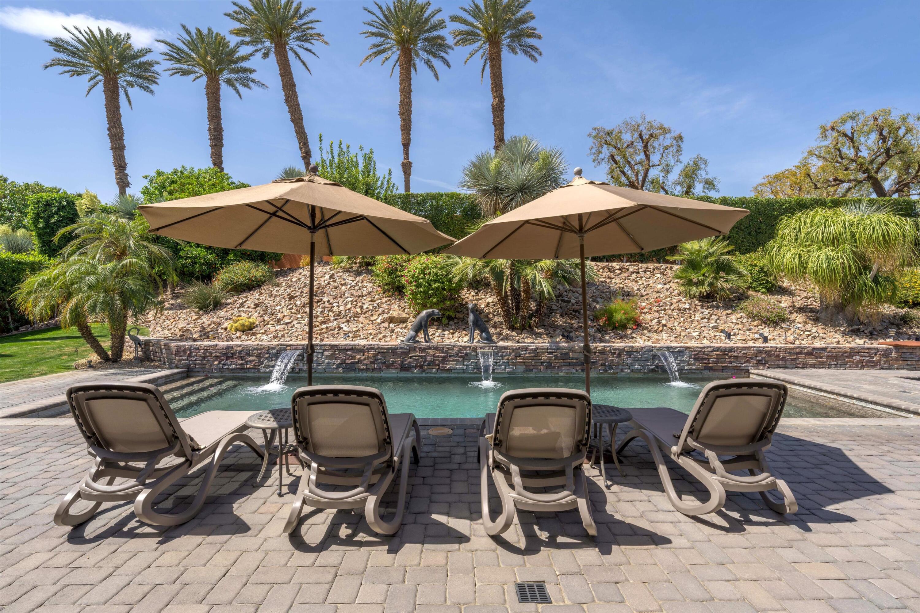79625 Vía Sin Cuidado La Quinta, CA 92253 - Photo 11 of 52 a view of a chairs and table in backyard