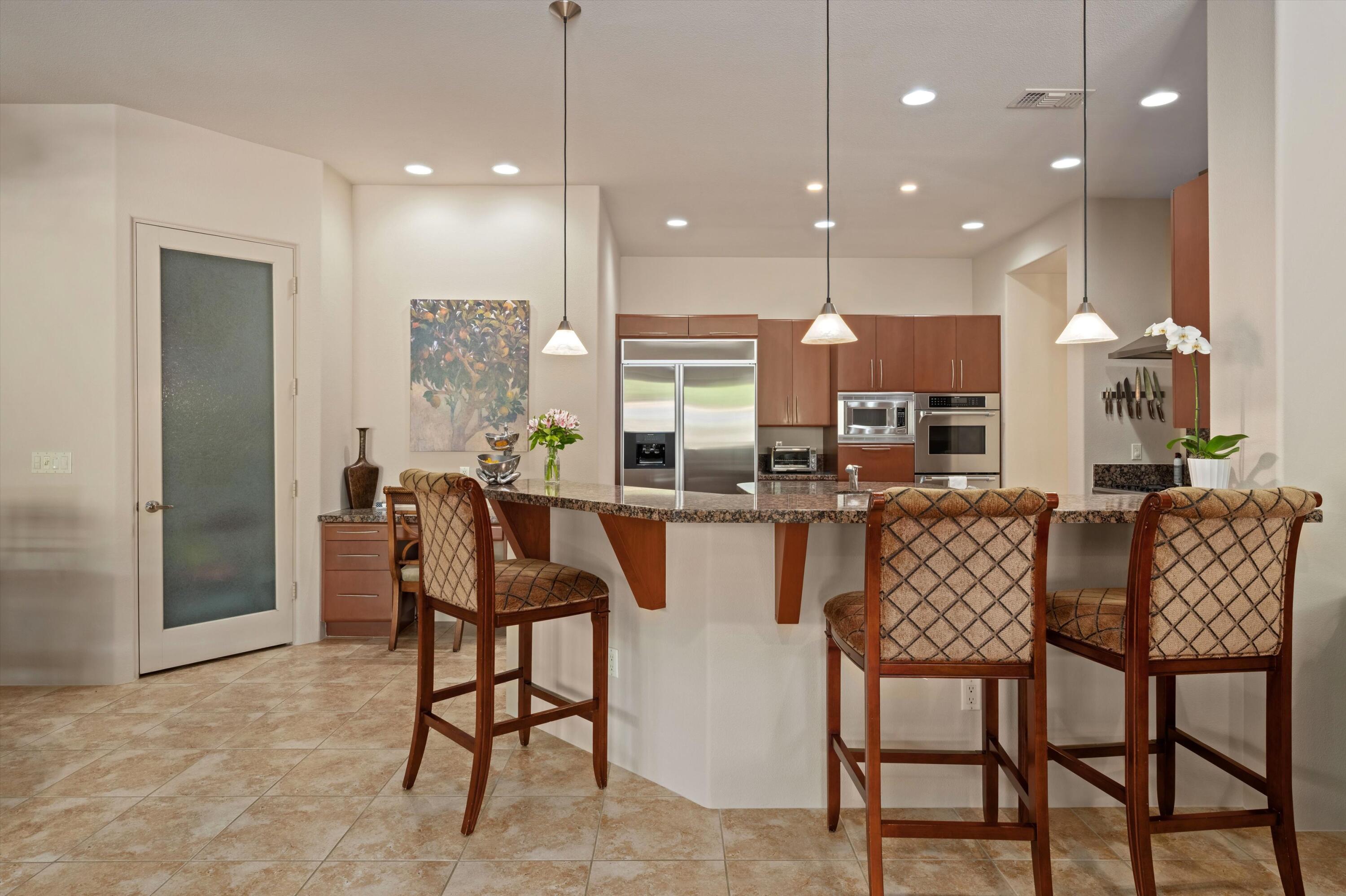 79625 Vía Sin Cuidado La Quinta, CA 92253 - Photo 27 of 52 a dining room kitchen with a table and chairs