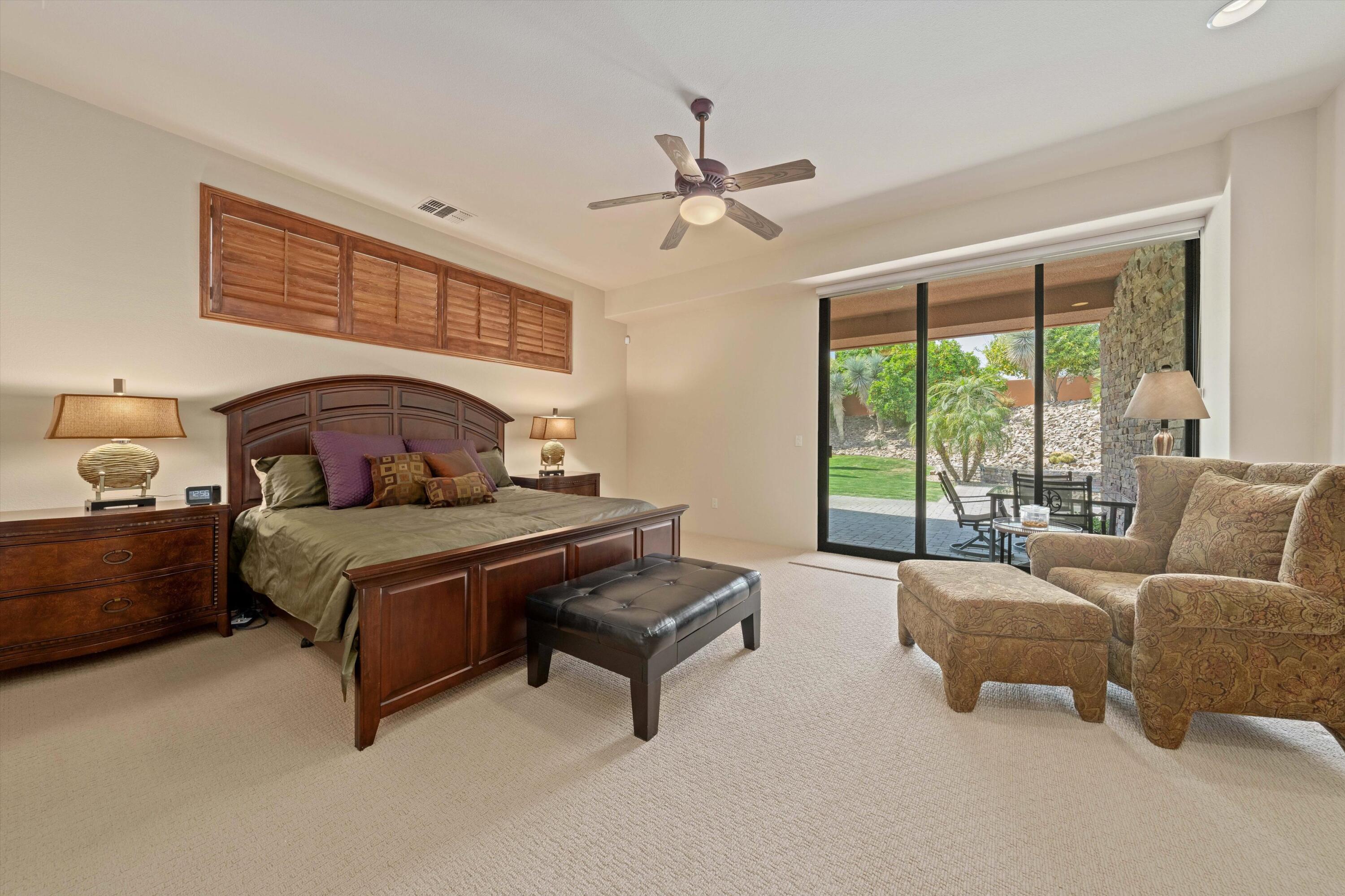 79625 Vía Sin Cuidado La Quinta, CA 92253 - Photo 36 of 52 a bedroom with a bed and a large window