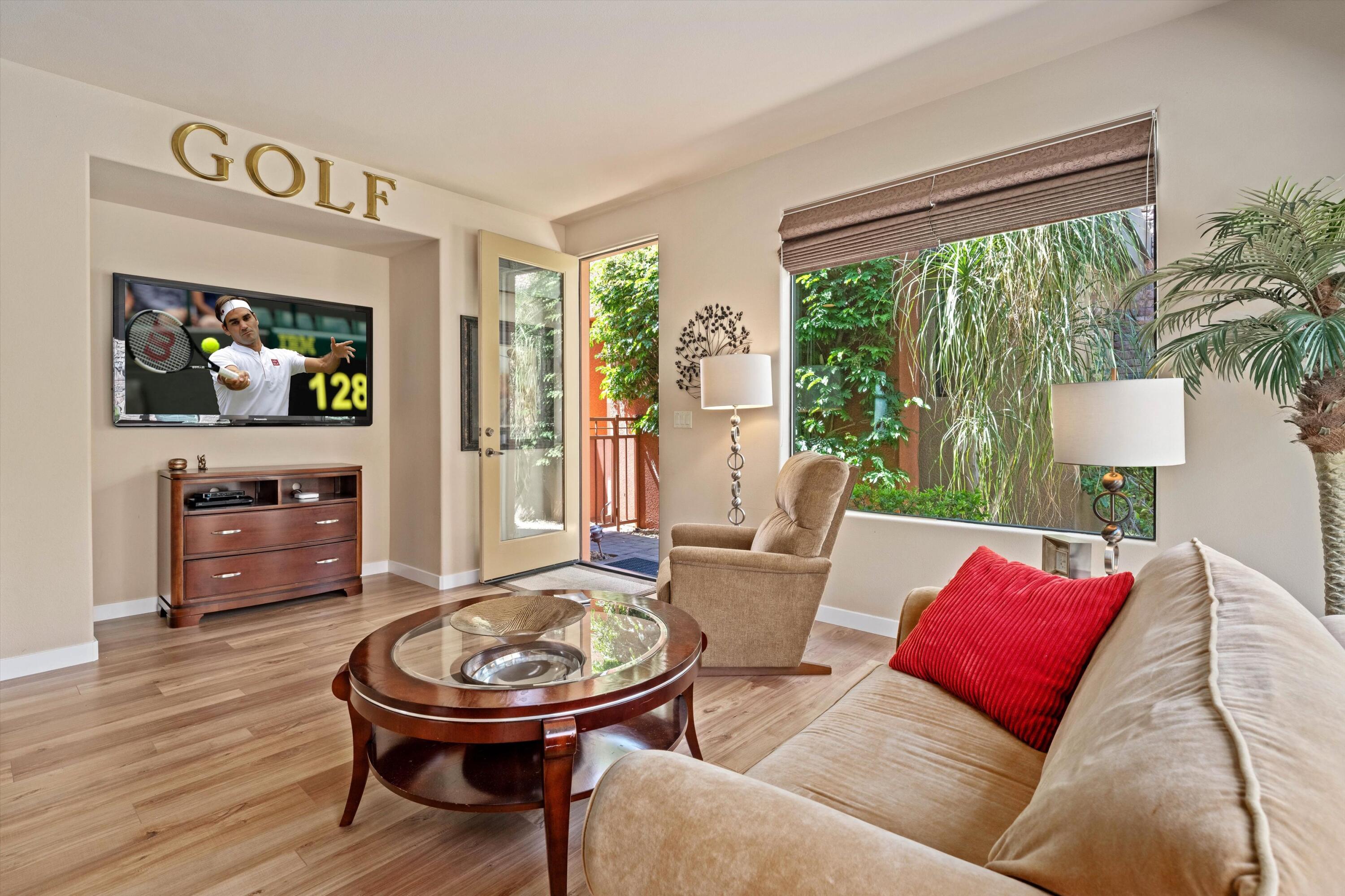 79625 Vía Sin Cuidado La Quinta, CA 92253 - Photo 48 of 52 a living room with furniture a flat screen tv and a large window
