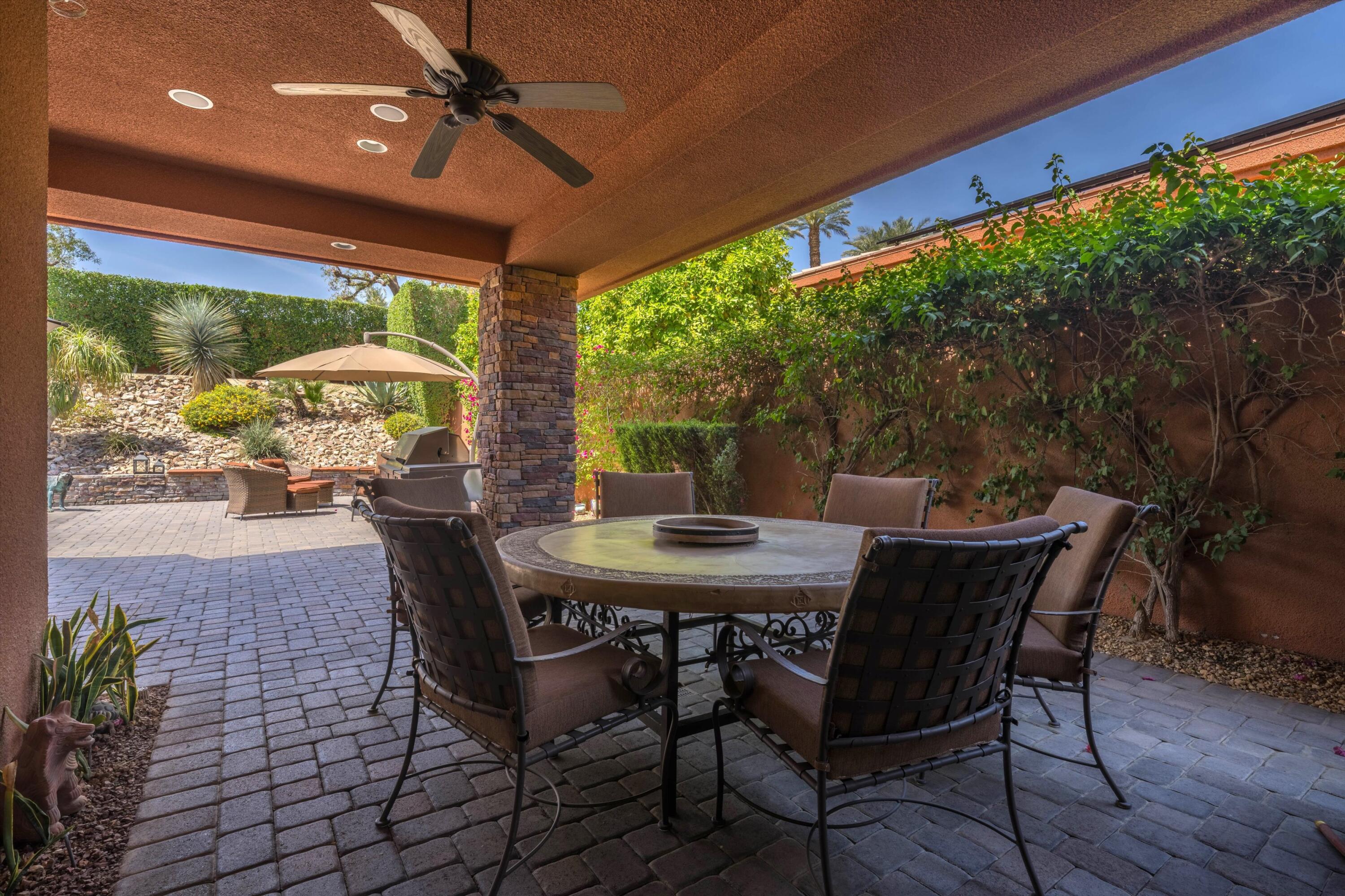 79625 Vía Sin Cuidado La Quinta, CA 92253 - Photo 9 of 52 a view of an outdoor dining space with furniture and garden view