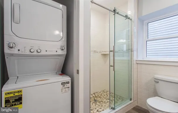 a bathroom with a toilet and a shower