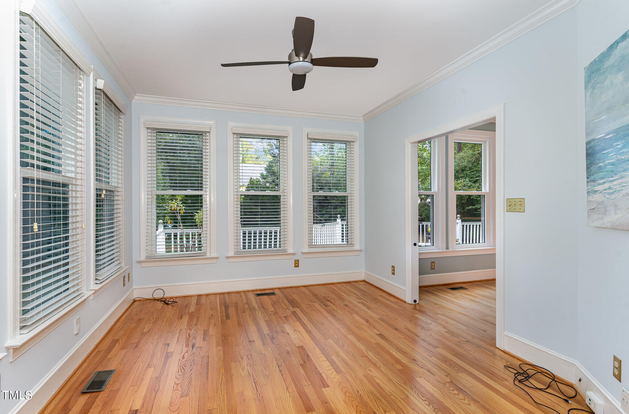 3008 Dunkirk Drive Raleigh, NC 27613 - Photo 12 of 33 a view of an empty room with wooden floor and a window