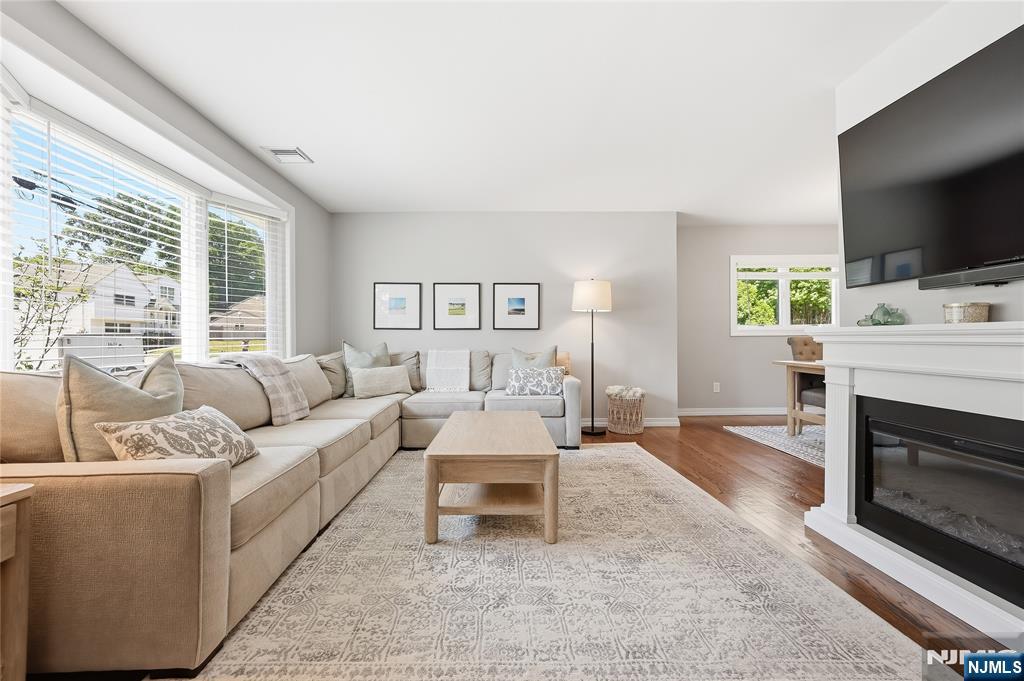 77 White Pond Road Waldwick, NJ 07463 - Photo 6 of 33 a living room with furniture a flat screen tv and a fireplace