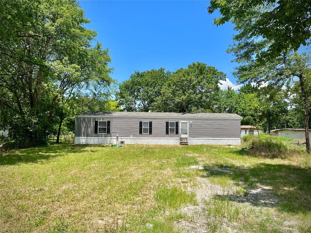 a front view of house with yard and trees