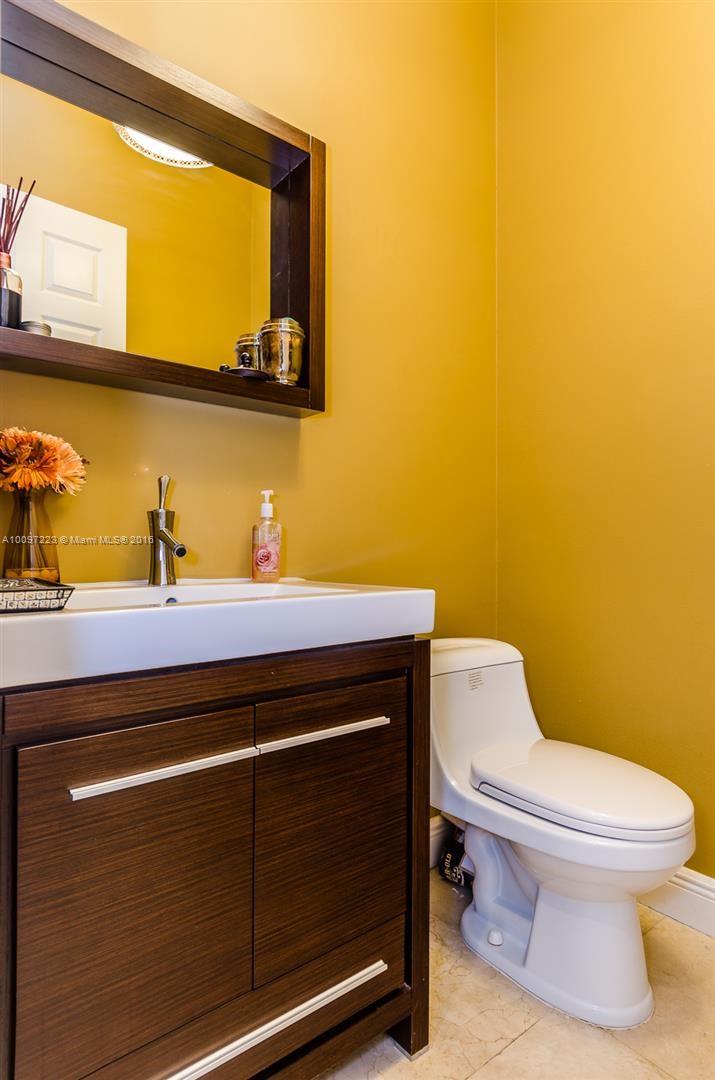 2633 Birch Terrace Davie, FL 33330 - Photo 12 of 35 a bathroom with a toilet a sink and mirror