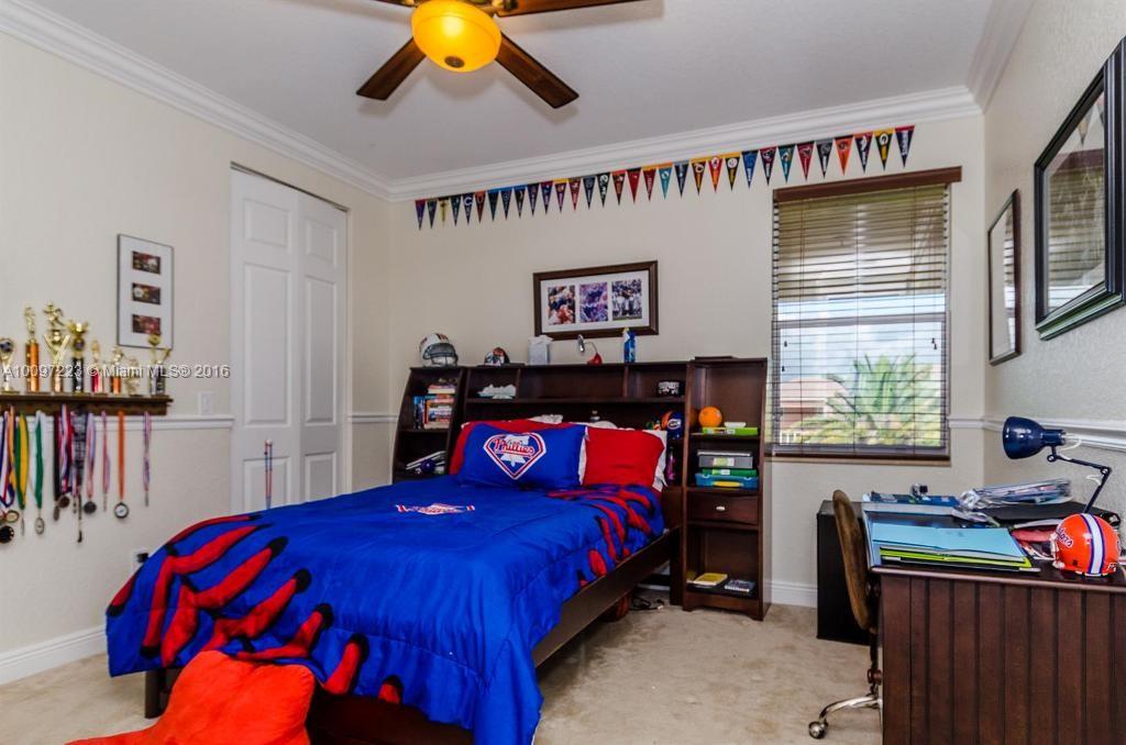 2633 Birch Terrace Davie, FL 33330 - Photo 22 of 35 a bedroom with a bed and a chandelier