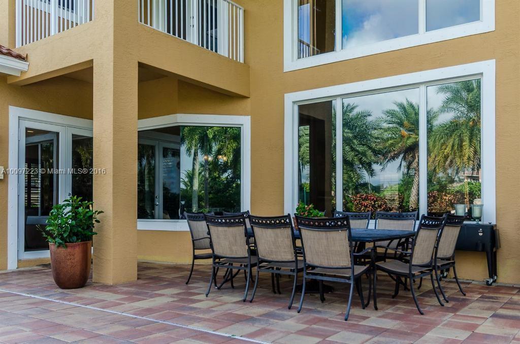 2633 Birch Terrace Davie, FL 33330 - Photo 32 of 35 a view of a patio with table and chairs potted plants and floor to ceiling window