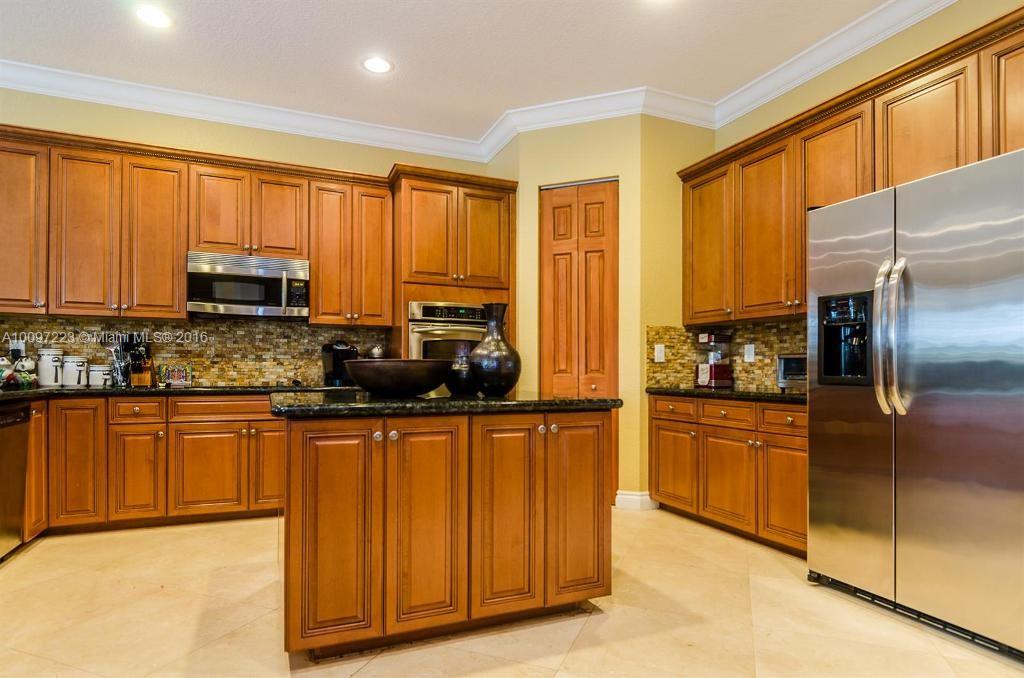 2633 Birch Terrace Davie, FL 33330 - Photo 8 of 35 a kitchen with stainless steel appliances granite countertop a refrigerator a stove top oven and a refrigerator