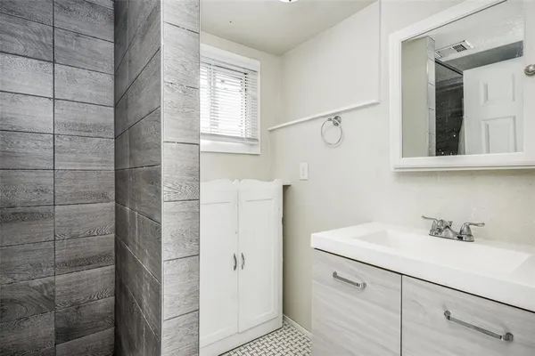 a bathroom with a sink and mirror