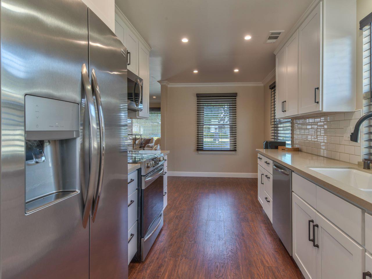 185 Riker Terrace Salinas, CA 93901 - Photo 9 of 19 a kitchen with stainless steel appliances granite countertop a refrigerator a sink a stove and wooden floors