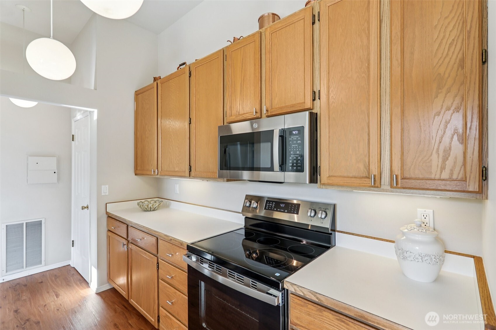 4222 221st Place Southeast, Unit 1081 Issaquah, WA 98029 - Photo 13 of 40 a kitchen with stainless steel appliances a stove a sink and a microwave