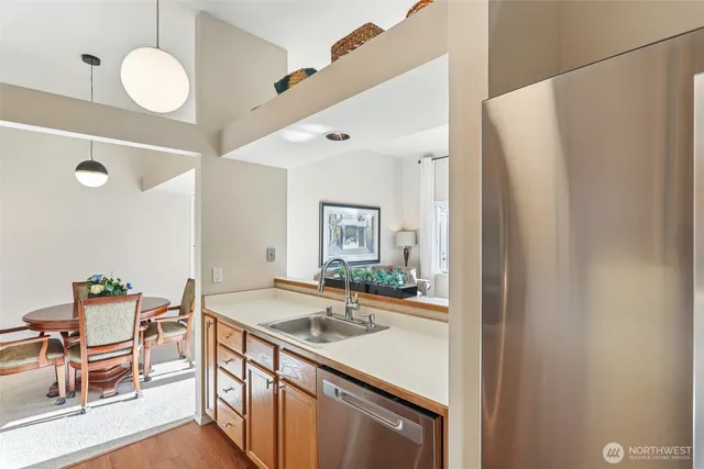 a kitchen that has a sink and a stove with chairs