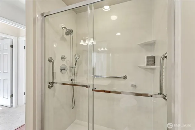 a bathroom with a glass shower door and a shower