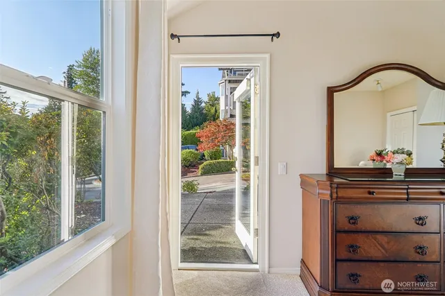 a view of a hallway with front door and wooden floor