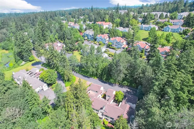 an aerial view of house with yard and mountain view in back