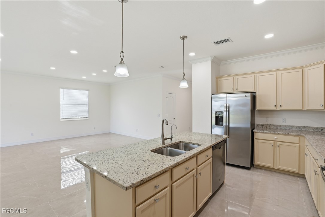 2251 Dancy Street Naples, FL 34120 - Photo 11 of 28 a kitchen with stainless steel appliances granite countertop a sink a refrigerator and a stove
