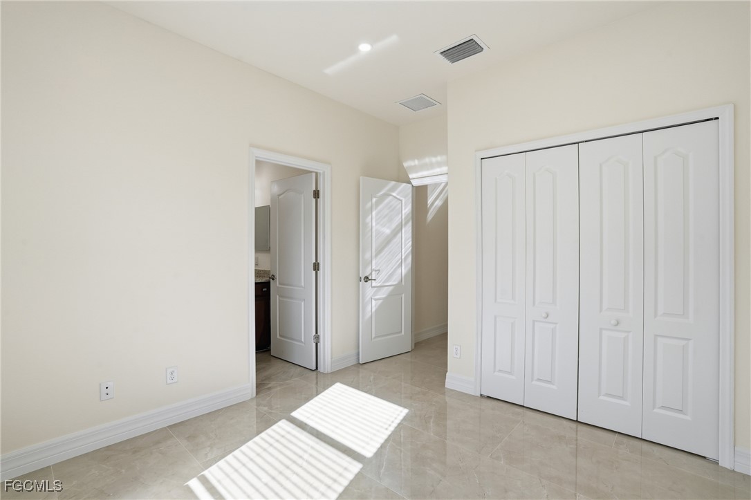 2251 Dancy Street Naples, FL 34120 - Photo 23 of 28 a view of a room with a walk in closet and wooden floor