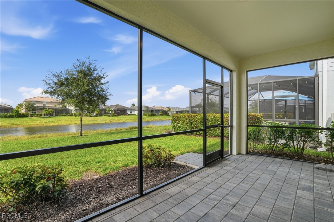 2251 Dancy Street Naples, FL 34120 - Photo 28 of 28 a view of a porch with a floor to ceiling window next to a yard