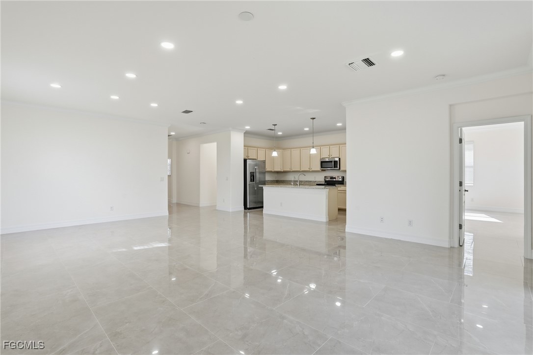 2251 Dancy Street Naples, FL 34120 - Photo 5 of 28 a view of kitchen with kitchen island and stainless steel appliances