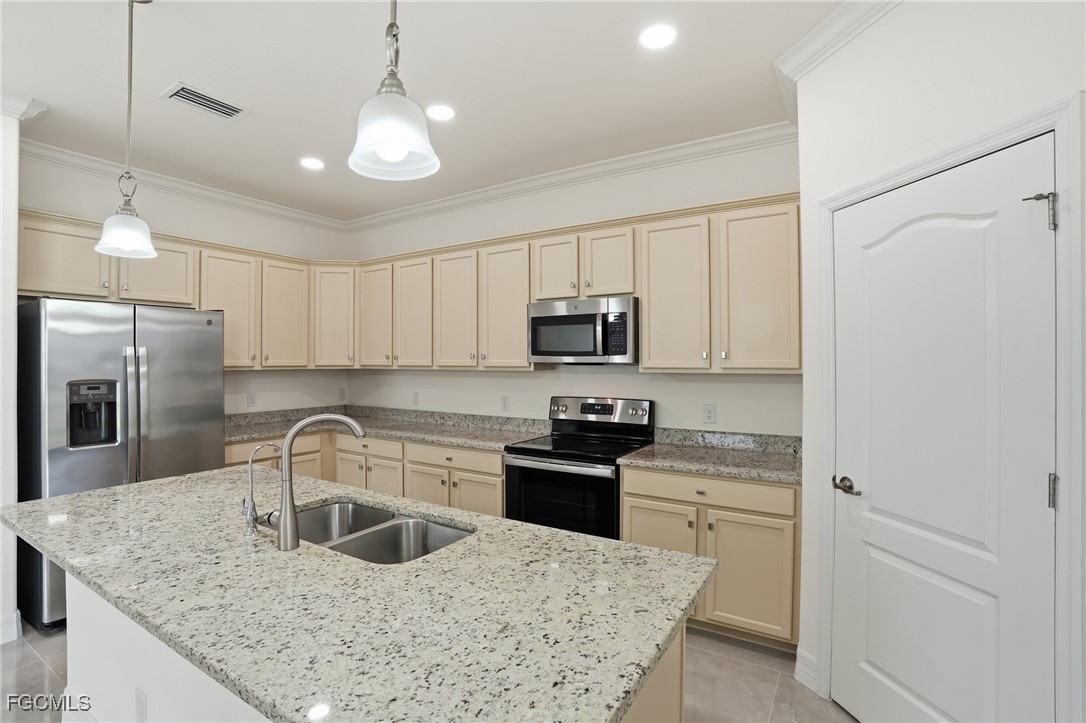 2251 Dancy Street Naples, FL 34120 - Photo 6 of 28 a kitchen with stainless steel appliances granite countertop a sink stove and refrigerator