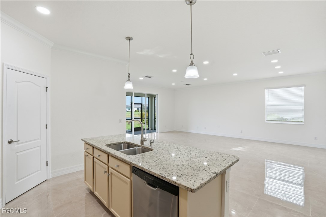 2251 Dancy Street Naples, FL 34120 - Photo 7 of 28 a kitchen with stainless steel appliances granite countertop a sink a refrigerator and a window