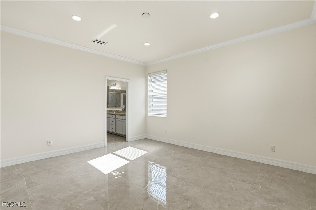 2251 Dancy Street Naples, FL 34120 - Photo 9 of 28 an empty room with windows and entrance