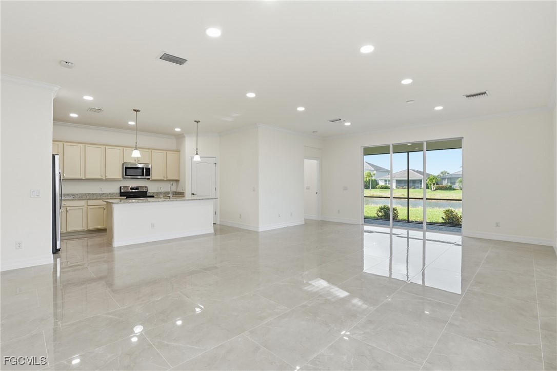 2251 Dancy Street Naples, FL 34120 - Photo 10 of 28 a open kitchen with white cabinets and stainless steel appliances
