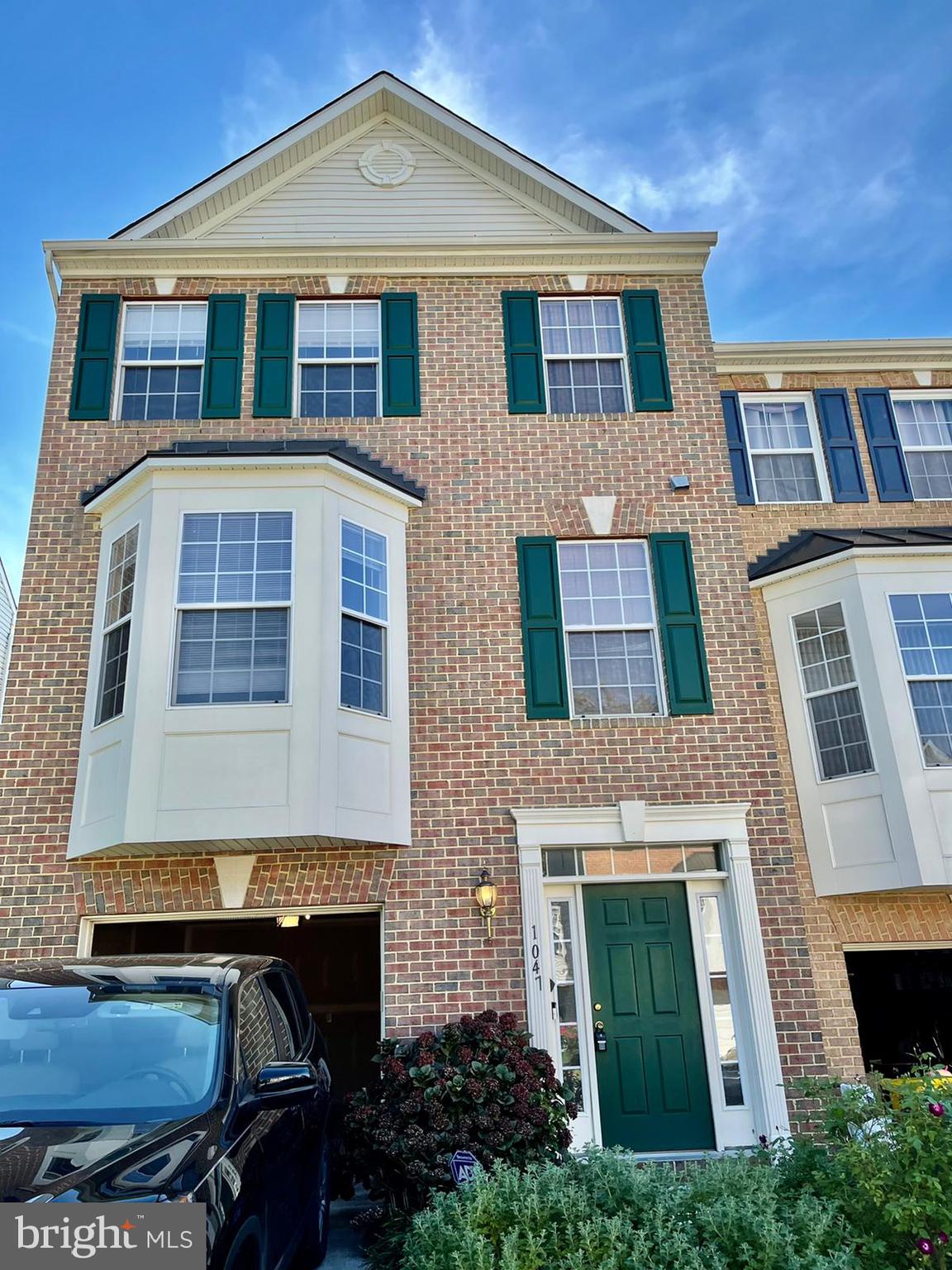 1047 Lily Way Odenton, MD 21113 - Photo 2 of 15 a front view of a house with a yard