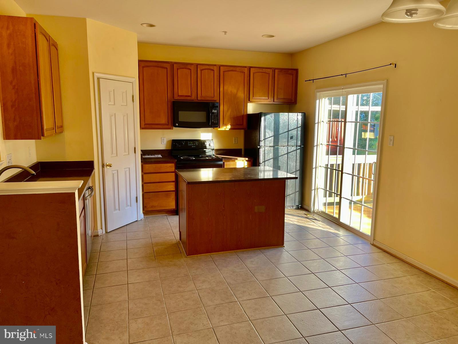 1047 Lily Way Odenton, MD 21113 - Photo 8 of 15 a kitchen with stainless steel appliances granite countertop a refrigerator a stove top oven a sink and dishwasher