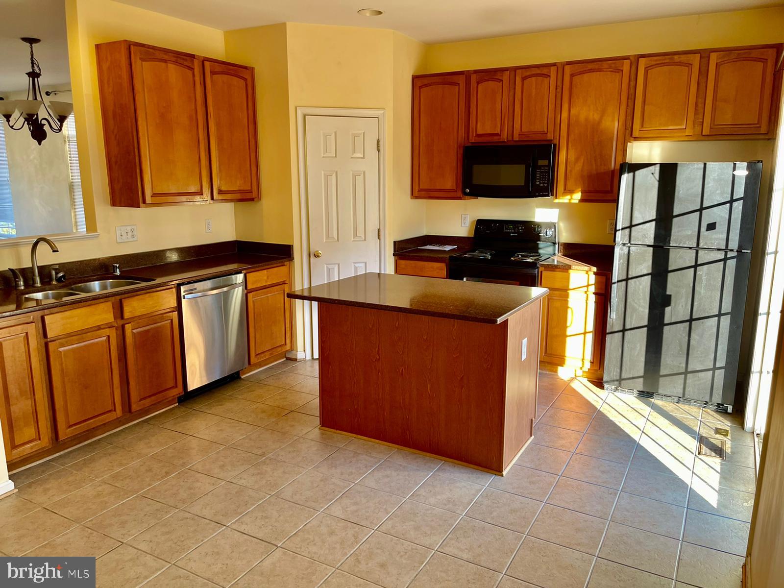 1047 Lily Way Odenton, MD 21113 - Photo 9 of 15 a kitchen with stainless steel appliances granite countertop a stove a sink and a microwave