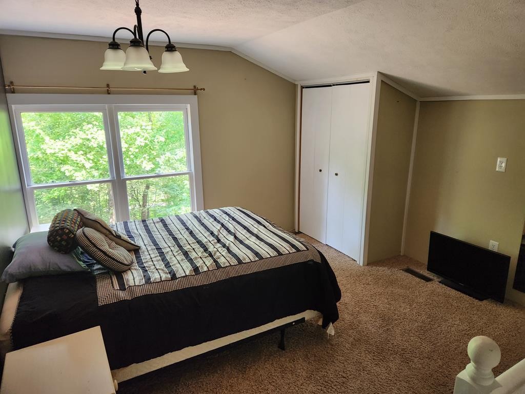 1939 Hodgetown Road Rutledge, TN 37861 - Photo 26 of 63 a bed sitting in a bedroom next to a window