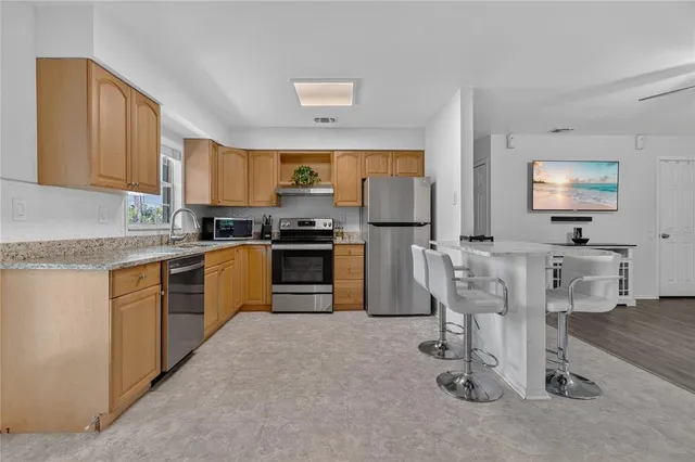 a kitchen with cabinets a sink and appliances
