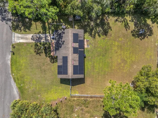a yellow building with trees in front of it