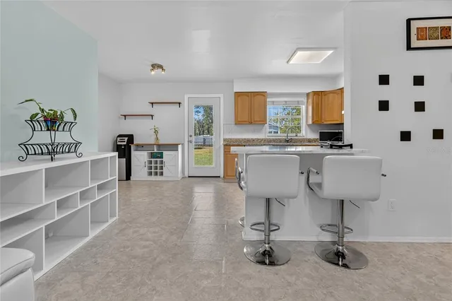 a view of a kitchen with kitchen island and stainless steel appliances
