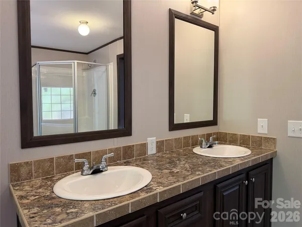 a bathroom with a sink double vanity and a mirror
