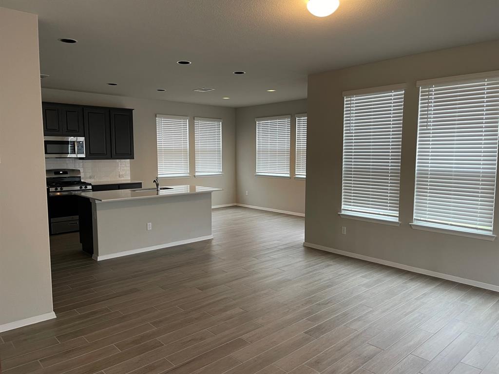 100 Crescent Street Georgetown, TX 78626 - Photo 17 of 17 a kitchen with stainless steel appliances granite countertop a stove a sink and a microwave
