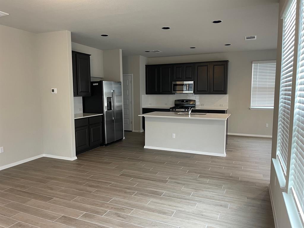 100 Crescent Street Georgetown, TX 78626 - Photo 2 of 17 a view of kitchen with stainless steel appliances wooden floor and window