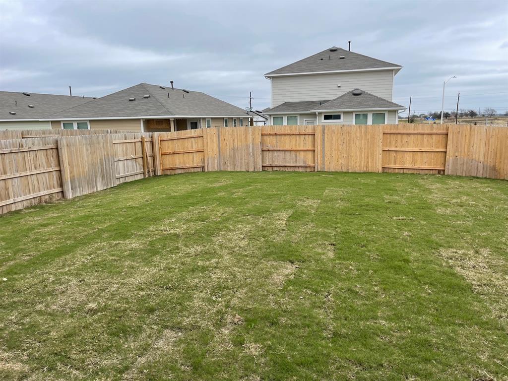 100 Crescent Street Georgetown, TX 78626 - Photo 4 of 17 a view of a backyard with a garden and entertaining space