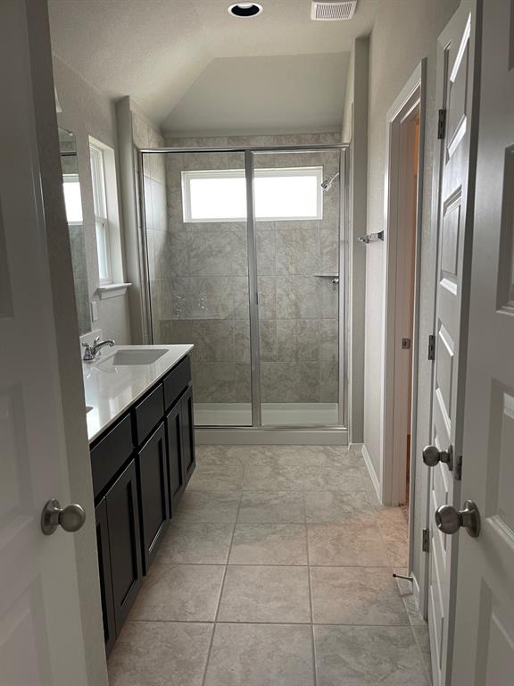100 Crescent Street Georgetown, TX 78626 - Photo 7 of 17 a bathroom with a granite countertop sink a mirror and a shower