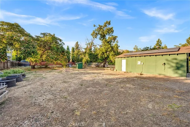 a backyard of a house with table and chairs