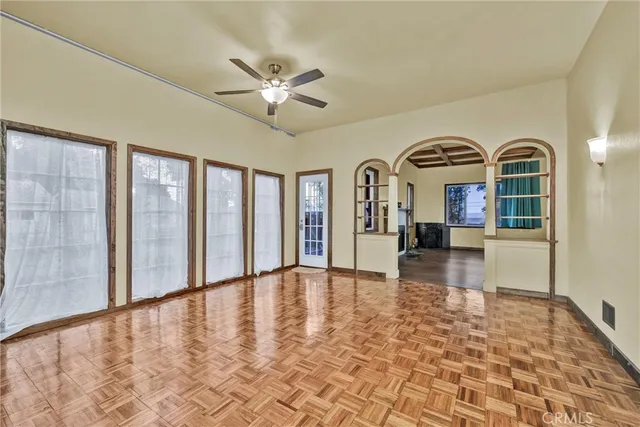 a view of a livingroom with a ceiling fan and window